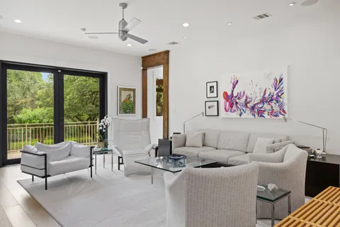 a living room with furniture and floor to ceiling window