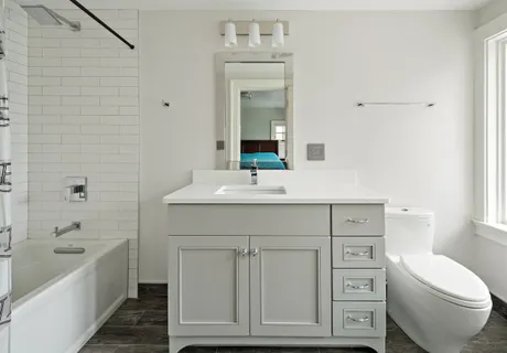 a bathroom with a toilet a sink a mirror and bathtub