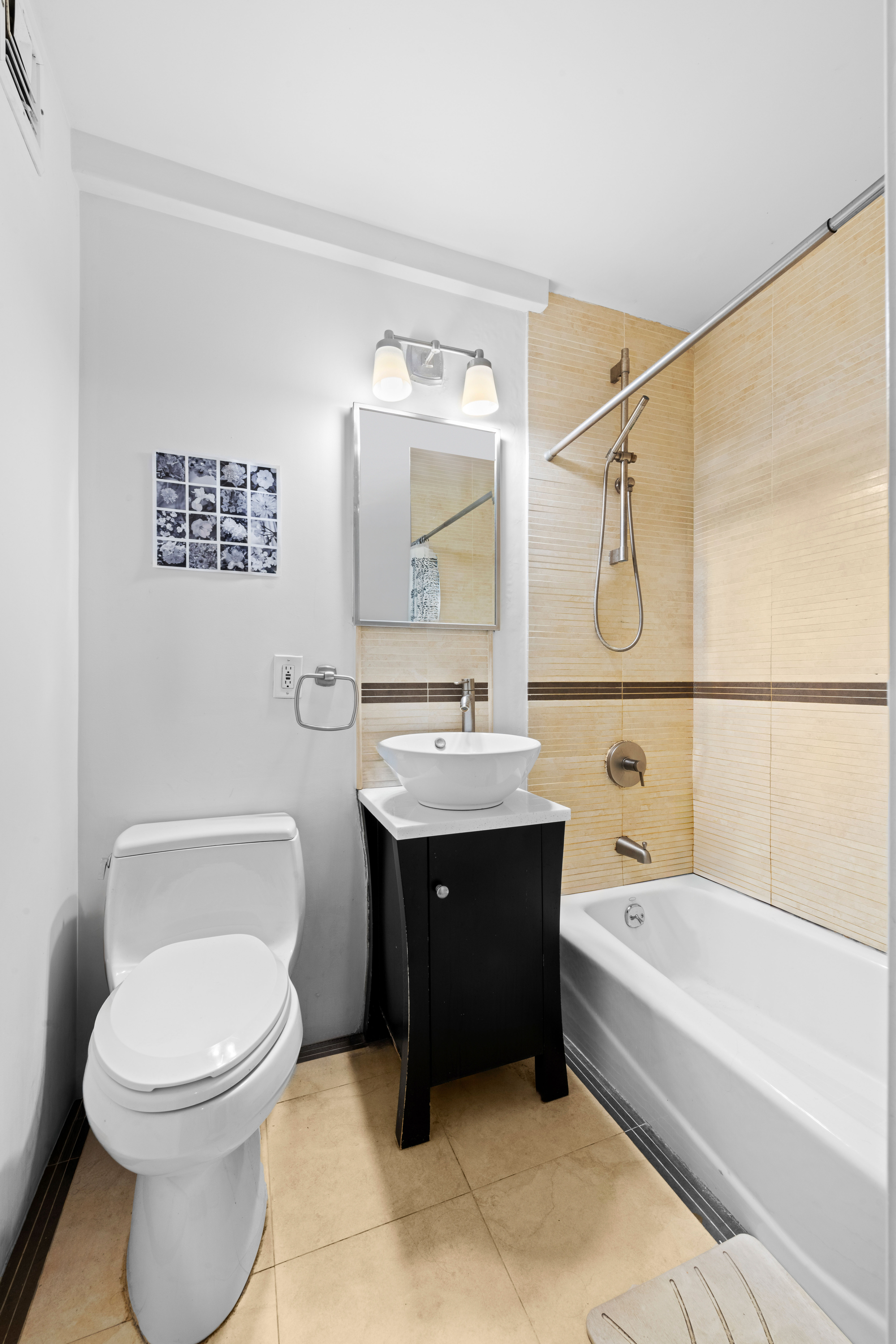 333 East 34th Street, Unit 5E Manhattan, NY 10016 - Photo 7 of 13 a bathroom with a sink a toilet and shower