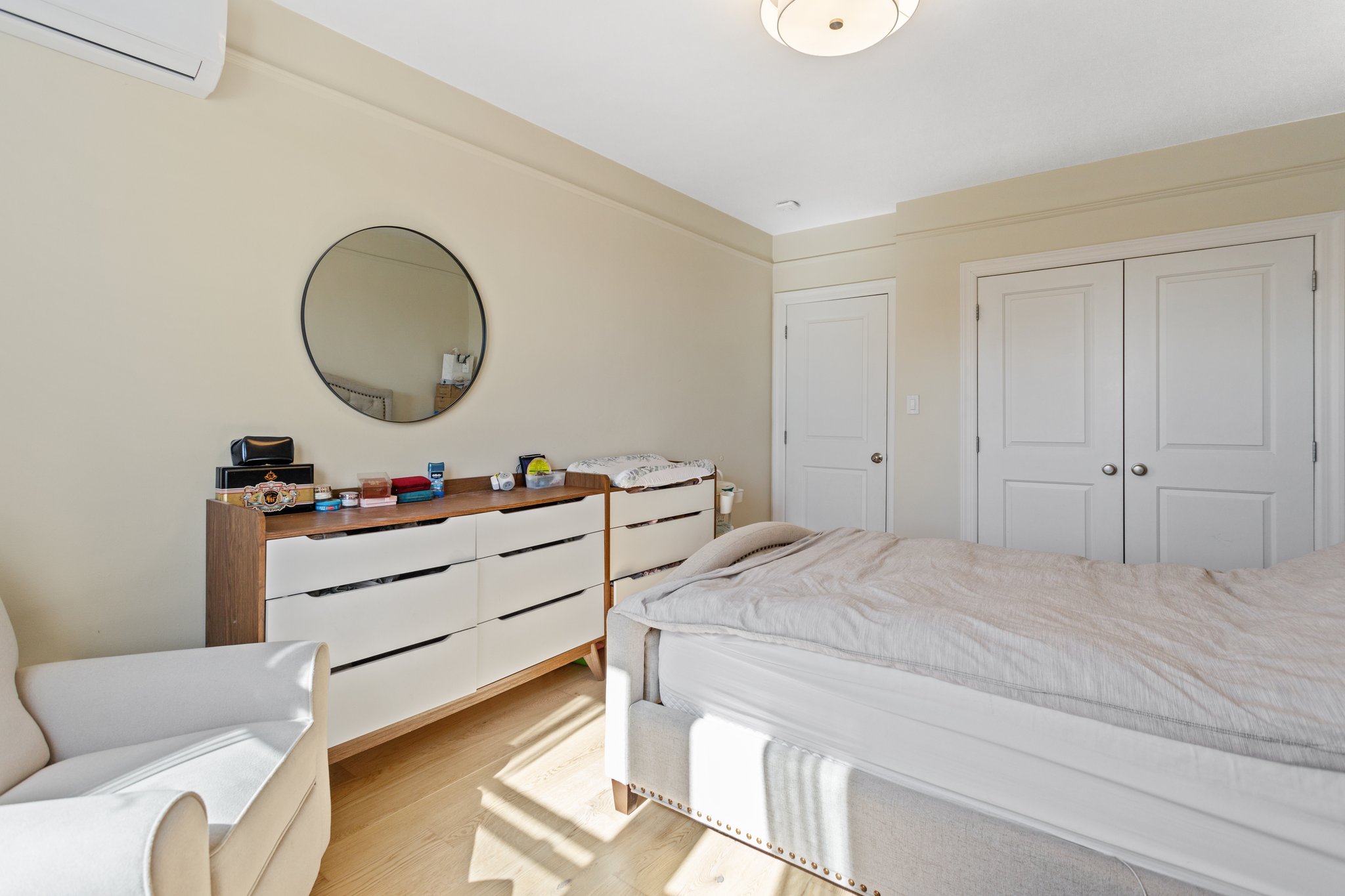 22-45 47th Street, Unit 3 Queens, NY 11105 - Photo 10 of 14 a bed room with a bed and a mirror