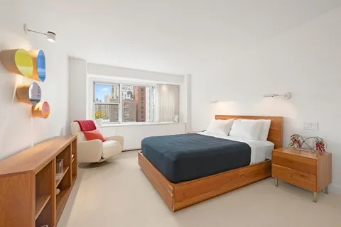 a bedroom with a bed and window