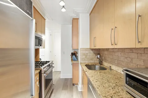 a kitchen with a refrigerator stove and sink