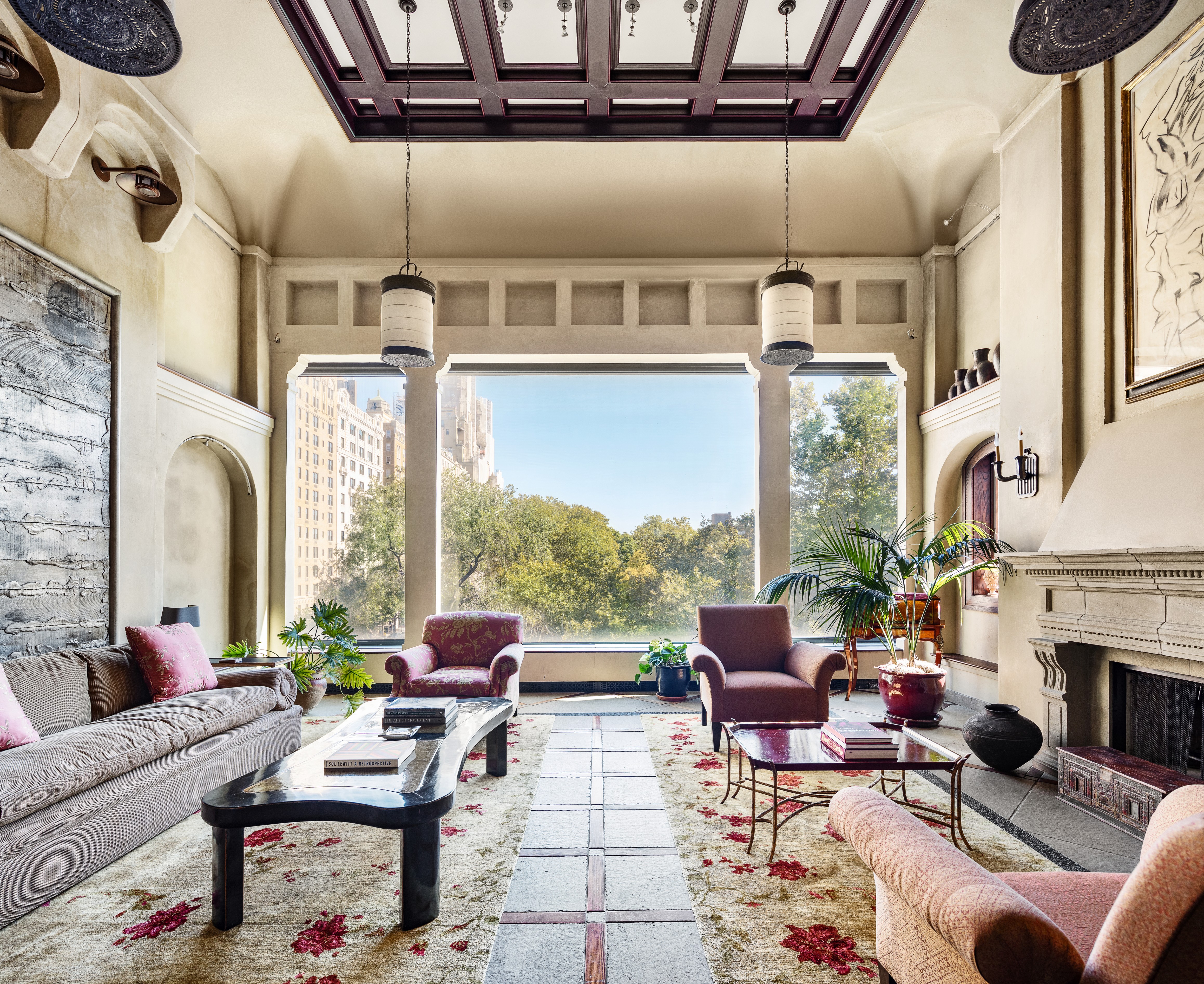 a living room with fireplace furniture and a floor to ceiling window