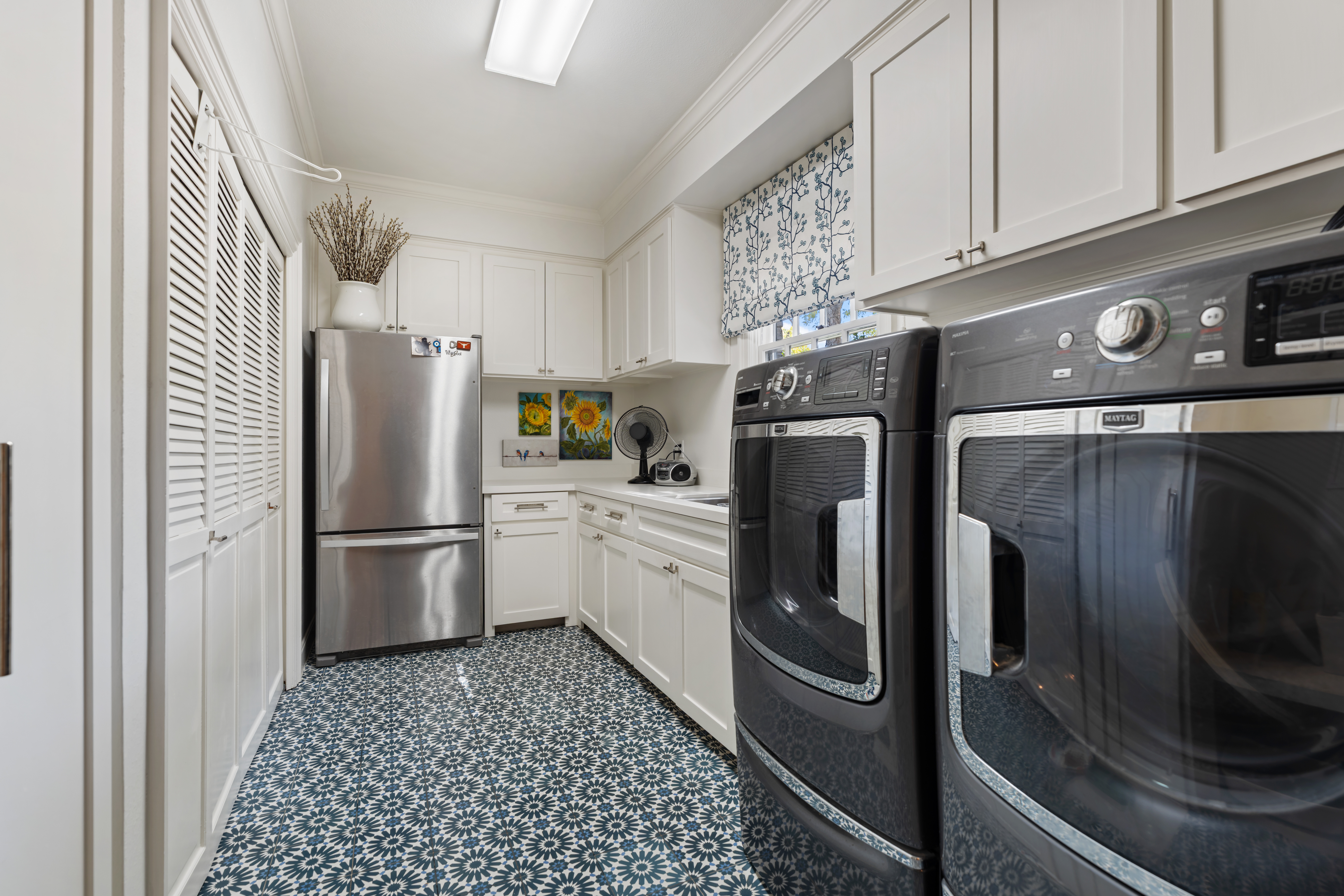 711 Pifer Road Houston, TX 77024 - Photo 43 of 53 a kitchen with stainless steel appliances a refrigerator a sink and cabinets