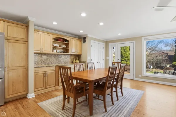 a dining room with furniture and wooden floor