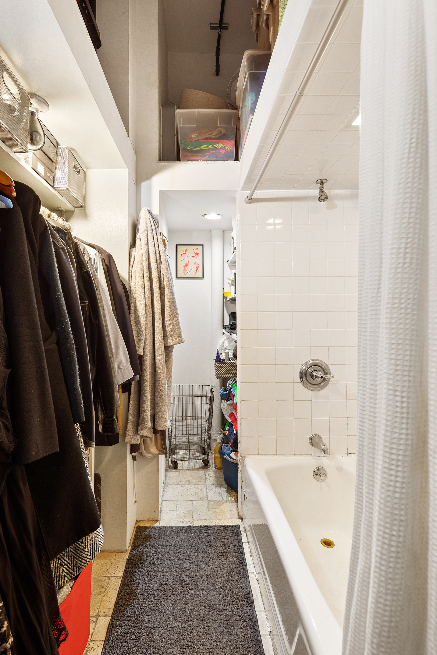 90 West Broadway, Unit 2B Manhattan, NY 10007 - Photo 7 of 12 a bathroom with a tub a sink and a large mirror