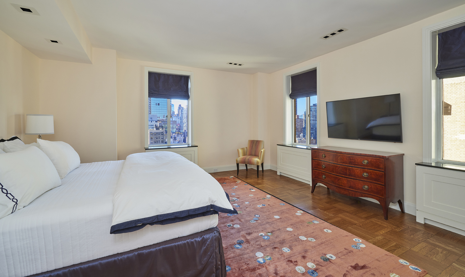 115 Central Park West, Unit 18JK Manhattan, NY 10023 - Photo 14 of 25 a bedroom with a bed and a flat screen tv