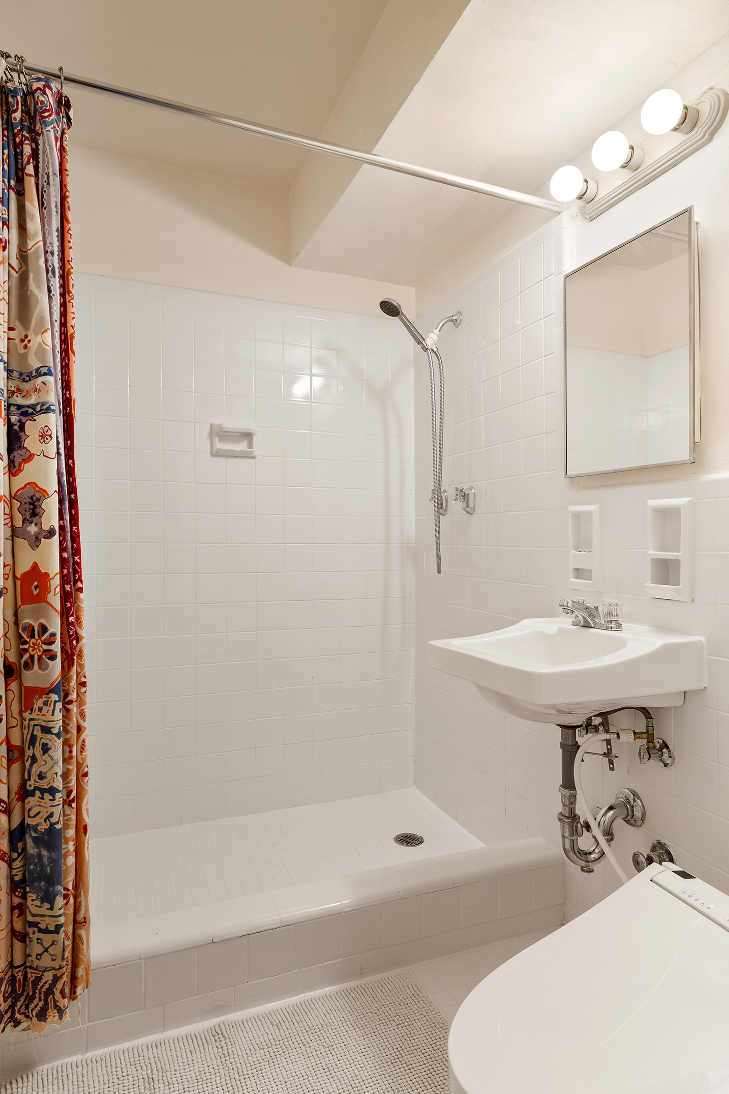 175 Willoughby Street, Unit 11L Brooklyn, NY 11201 - Photo 8 of 16 a bathroom with a sink a toilet and shower