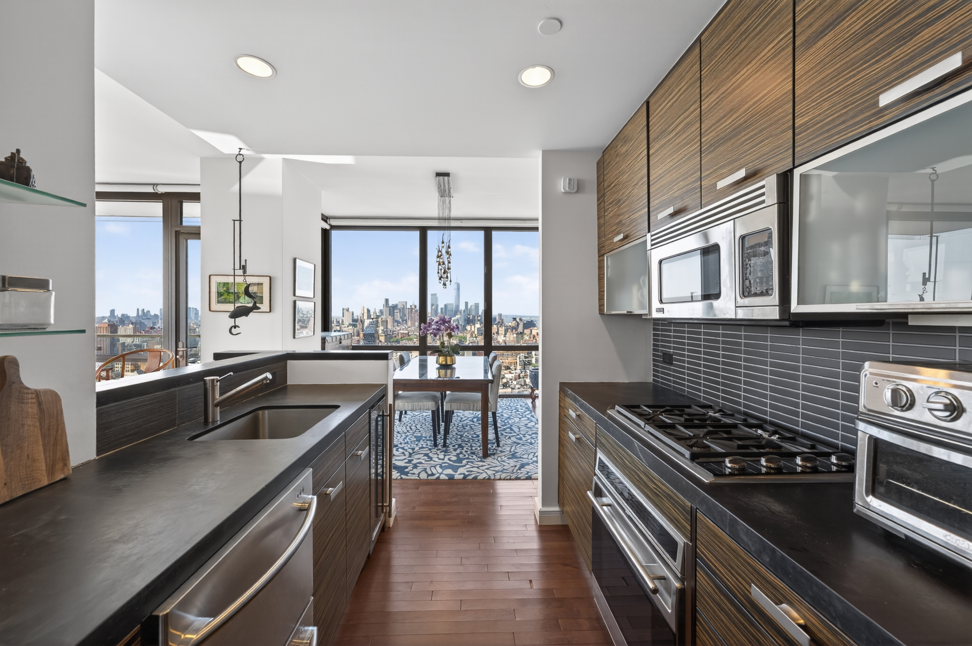 101 West 24th Street, Unit 36C Manhattan, NY 10011 - Photo 11 of 27 a kitchen with a stove a sink and a granite counter top
