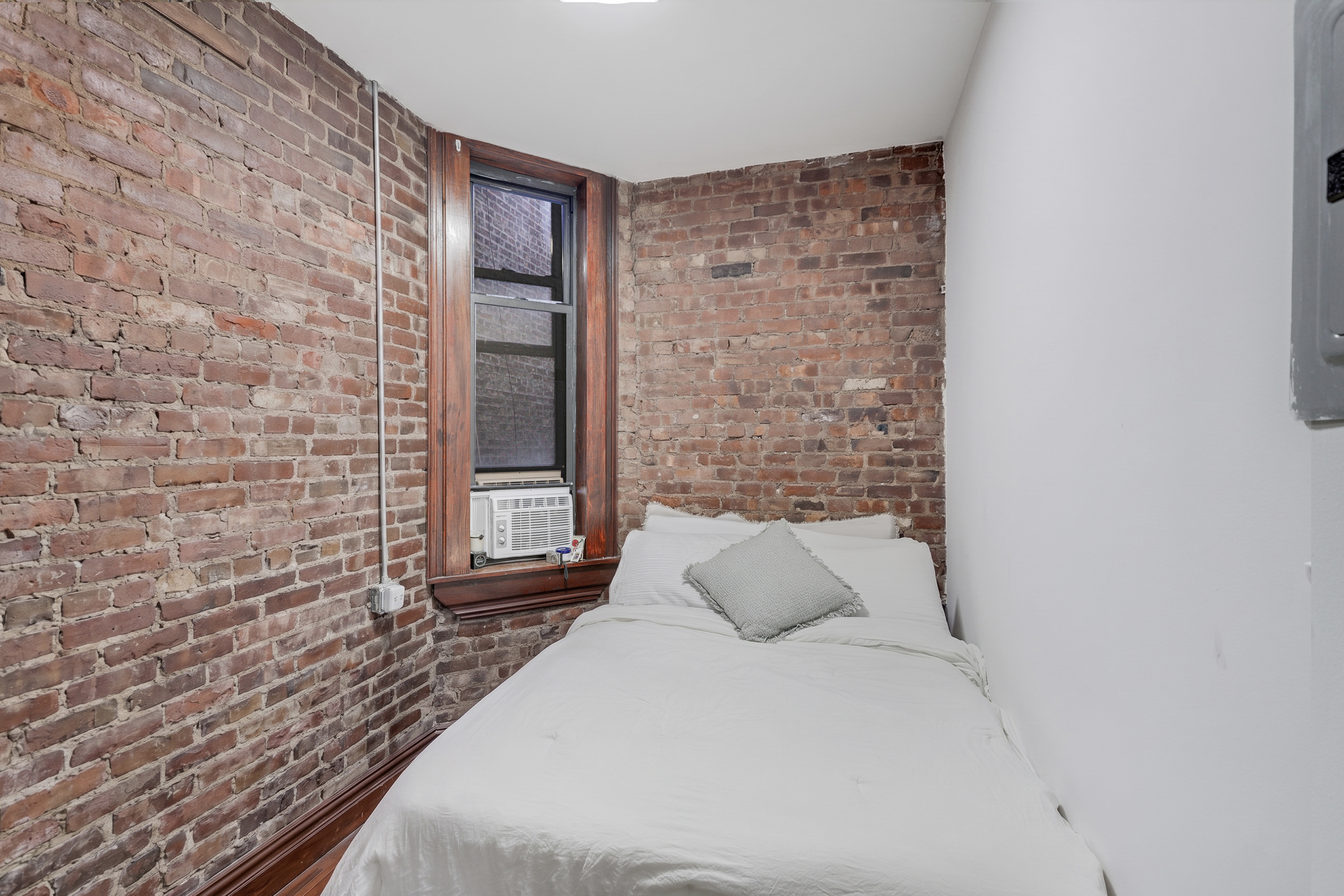 336 East 5th Street, Unit 3FE Manhattan, NY 10003 - Photo 3 of 4 a bedroom with a bed and a window