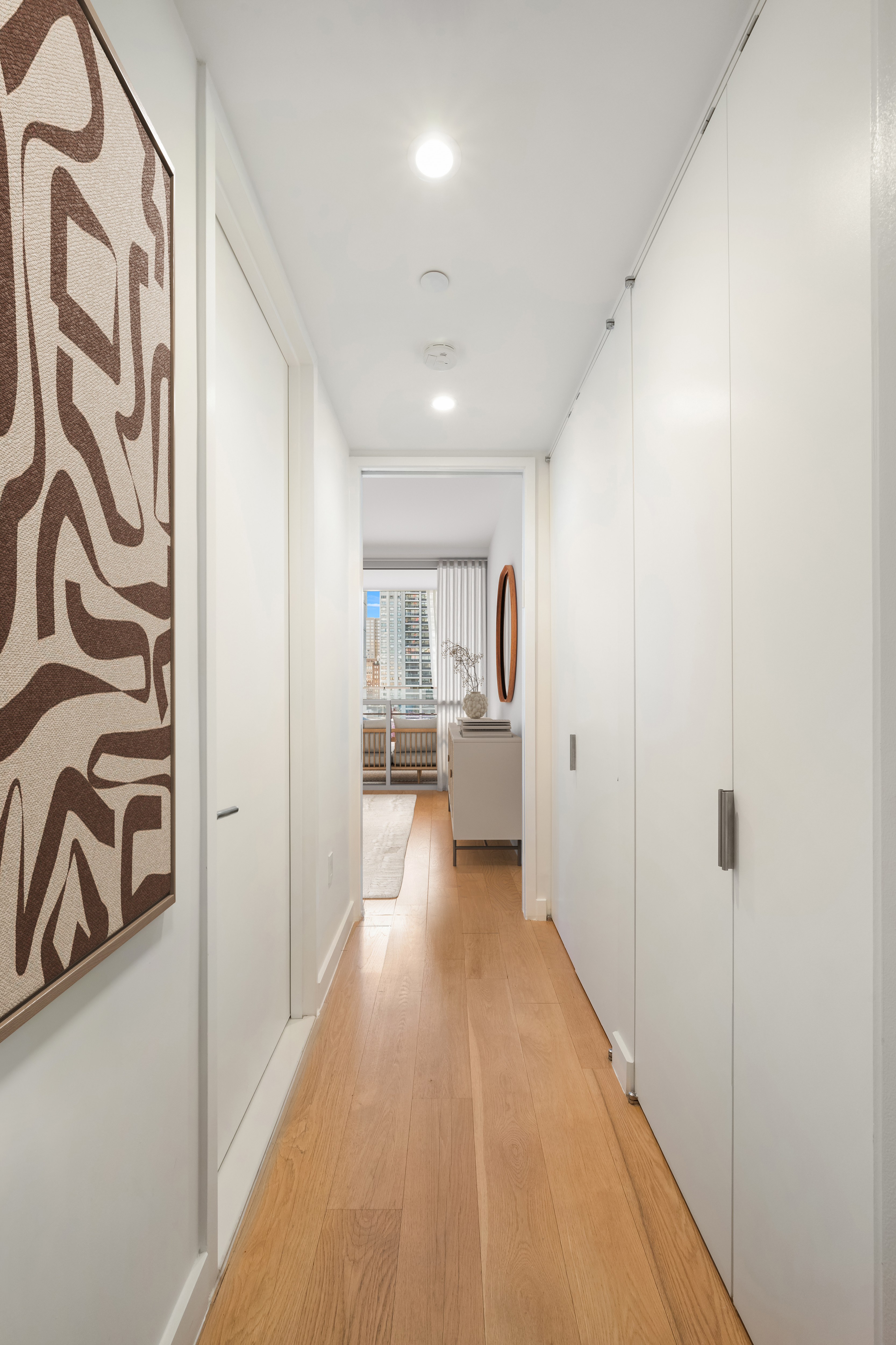 301 East 61st Street, Unit 10B Manhattan, NY 10065 - Photo 8 of 9 a view of a hallway with a dining table chairs