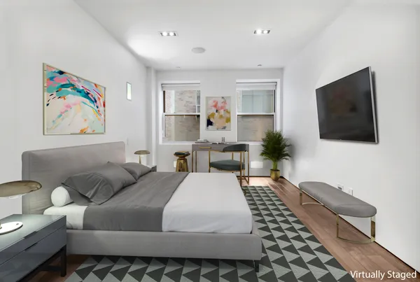 a bedroom with a bed and a flat screen tv