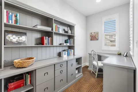 a bathroom with a granite countertop double vanity sink a mirror and a bathtub