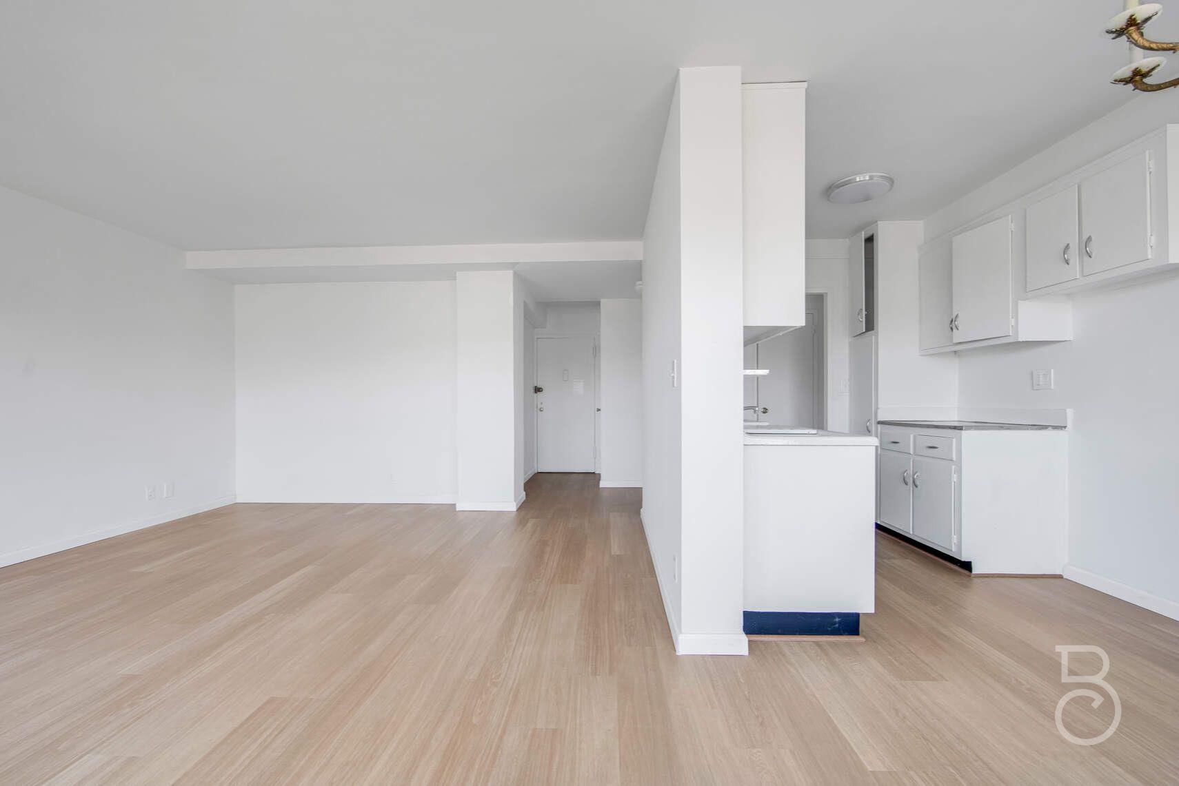 33-65 14th Street, Unit 5D Queens, NY 11106 - Photo 4 of 11 a view of kitchen with wooden floor