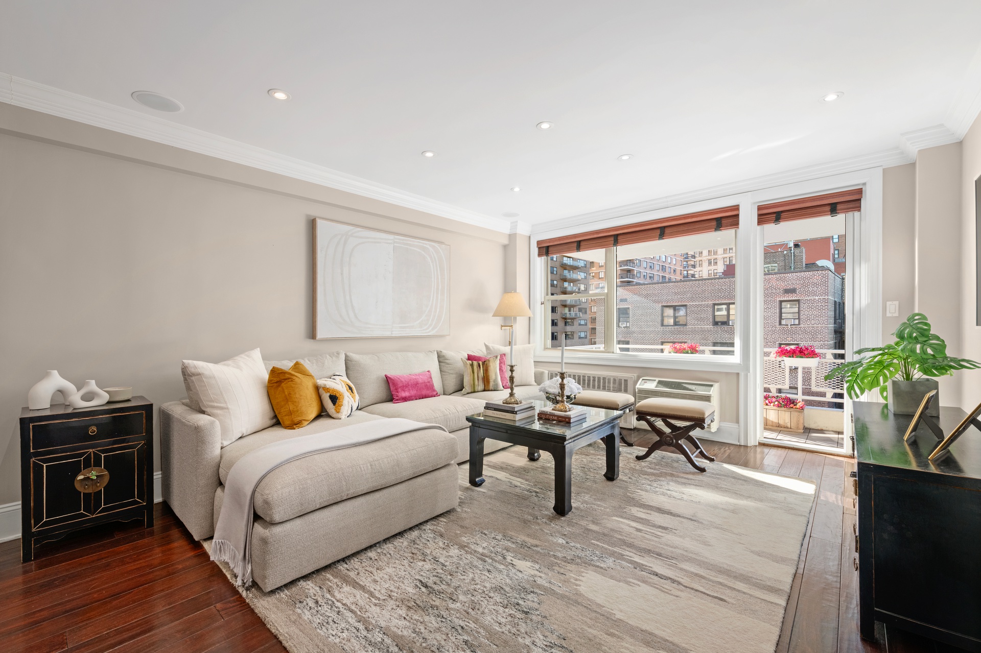 a living room with furniture and a potted plant