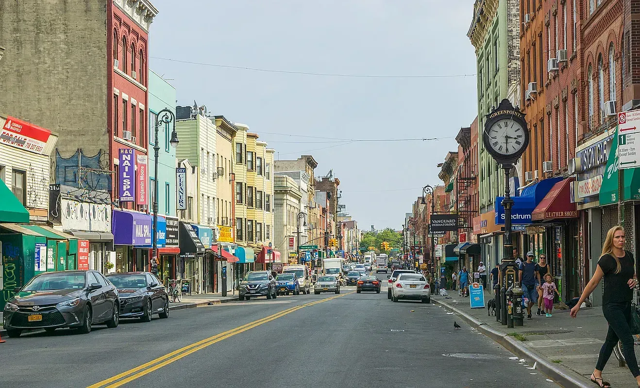 a city street lined with buildings and cars parked on the street