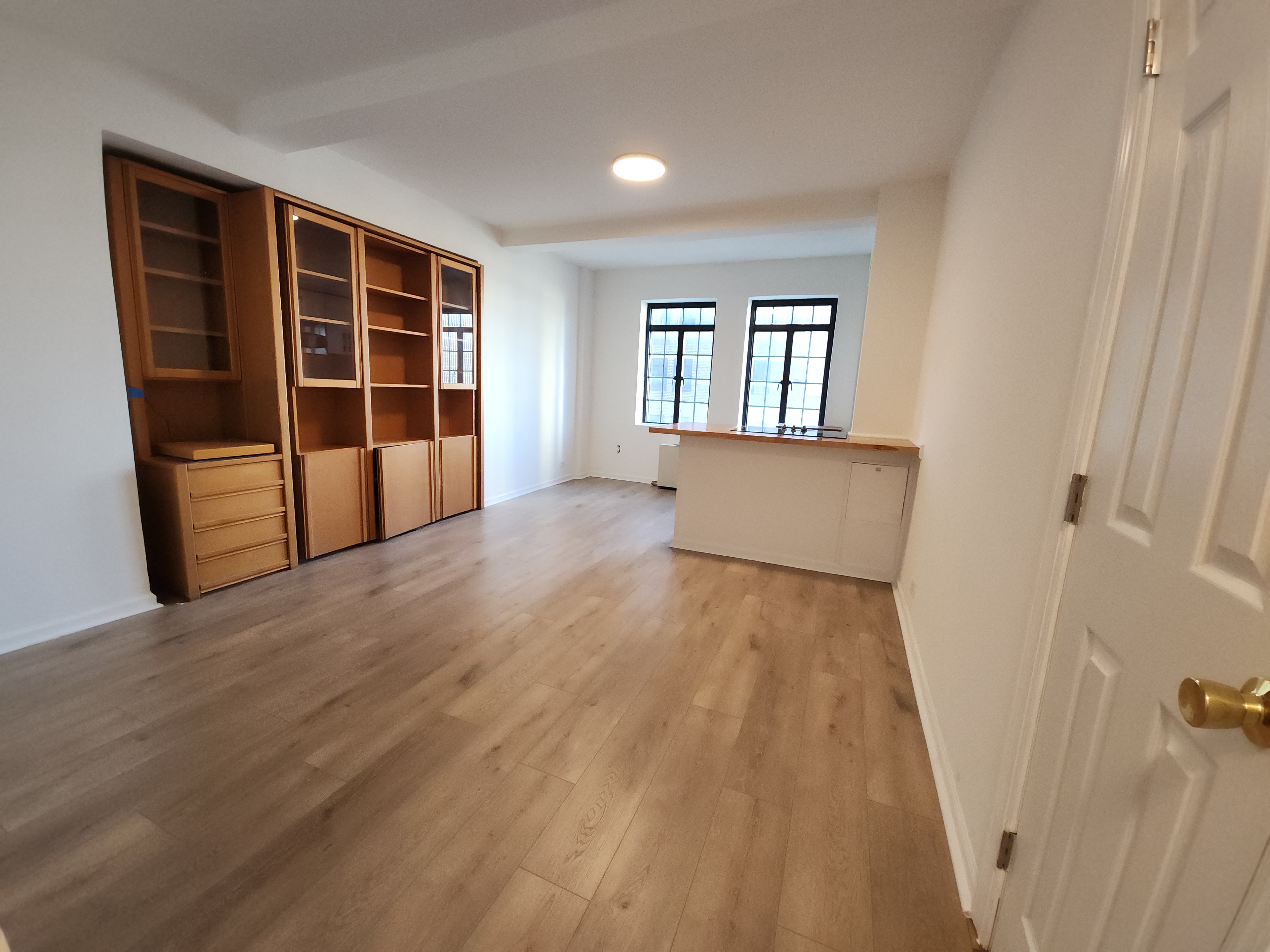 5 Tudor City Place, Unit 602 Manhattan, NY 10017 - Photo 10 of 20 wooden floor in an empty room with a window