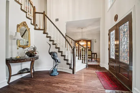 a view of entryway and hall with wooden floor
