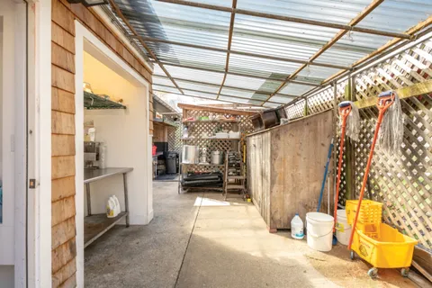 a view of a porch with furniture and a garage
