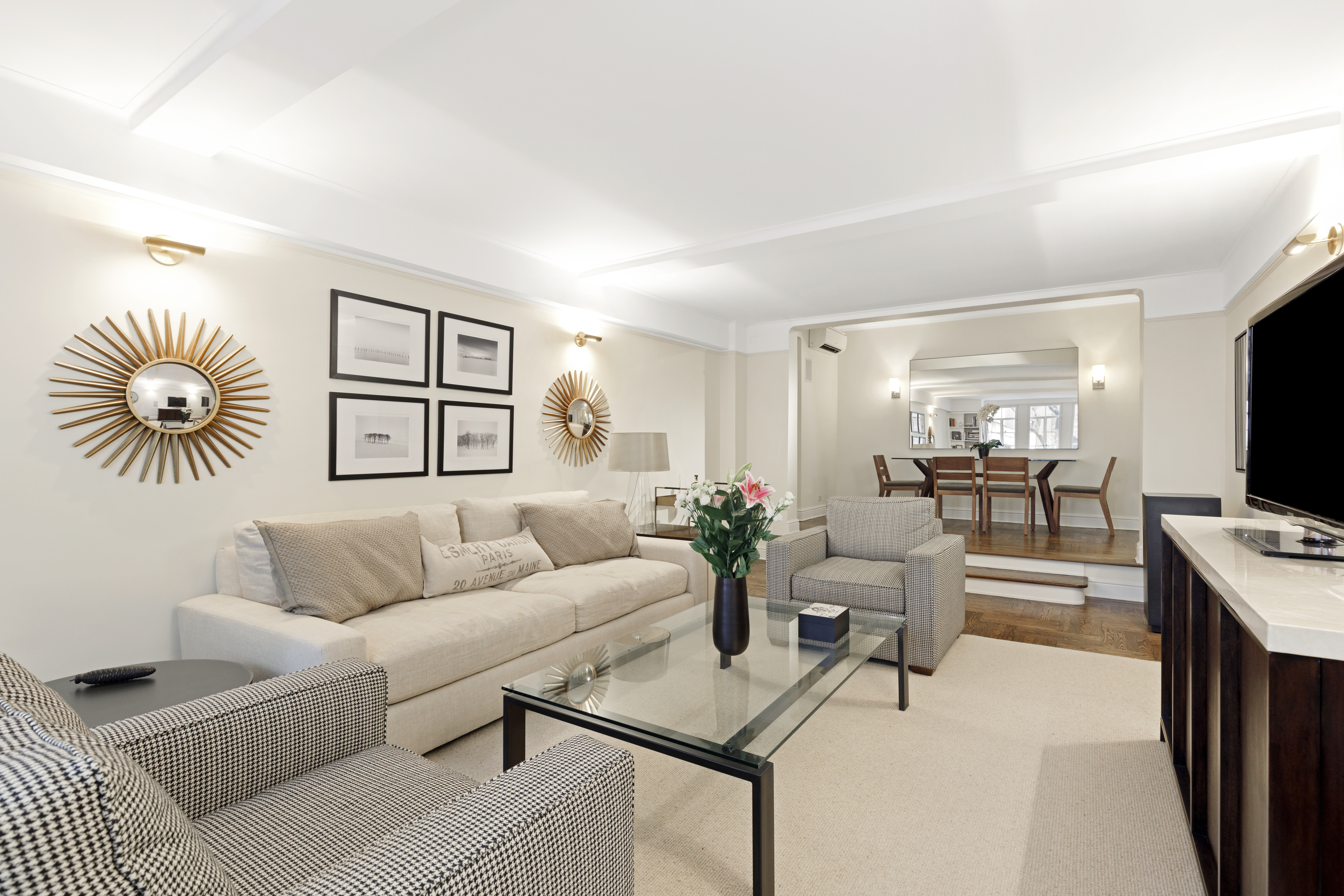 110 East 87th Street, Unit 2C Manhattan, NY 10128 - Photo 3 of 12 a living room with furniture and a flat screen tv