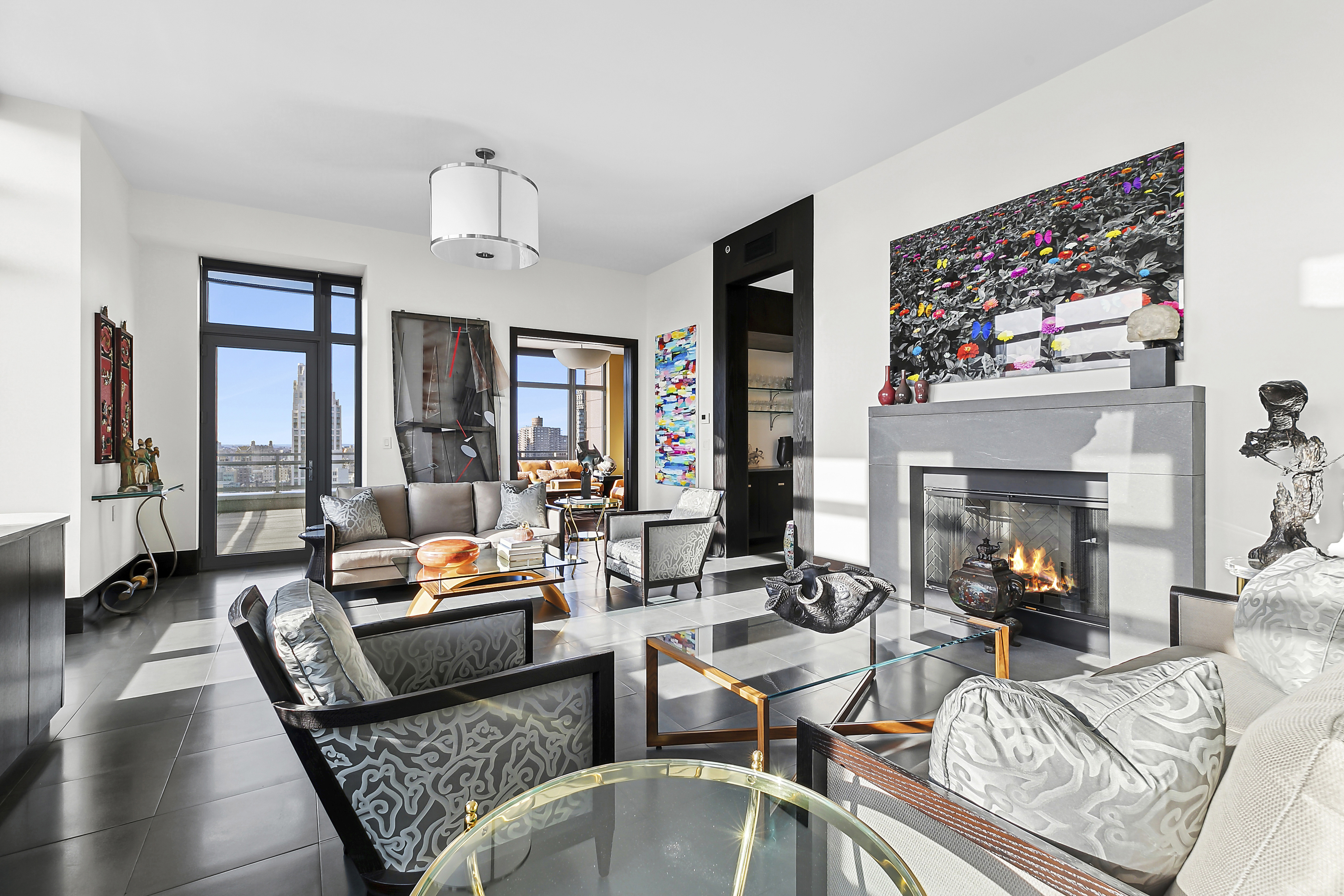 450 East 83rd Street, Unit PH1B Manhattan, NY 10028 - Photo 2 of 15 a living room with furniture fireplace and flat screen tv