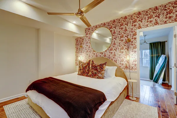 a bedroom with a bed and wooden floor