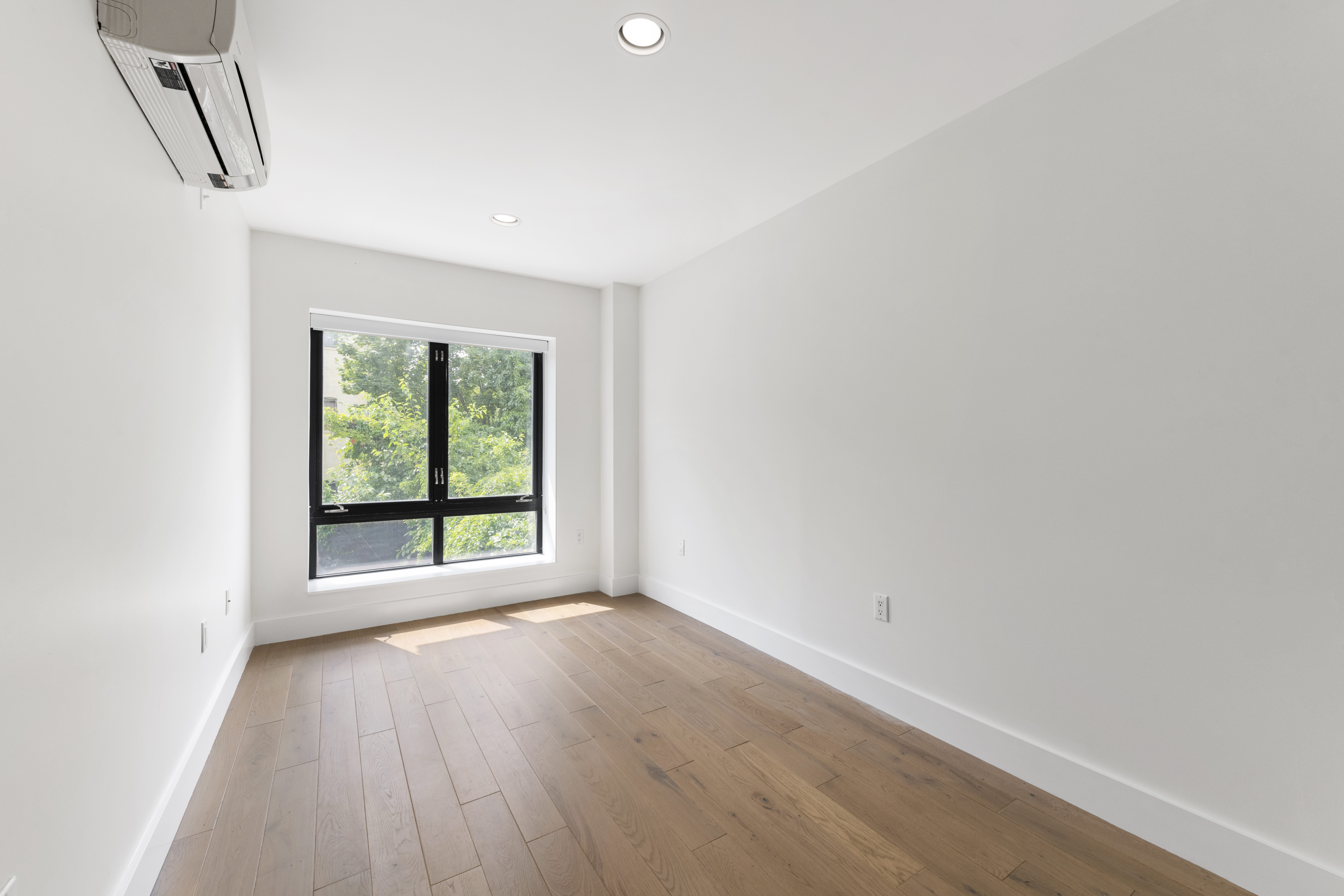 1168 Greene Avenue, Unit 2B Brooklyn, NY 11221 - Photo 5 of 11 a view of an empty room with wooden floor and a window
