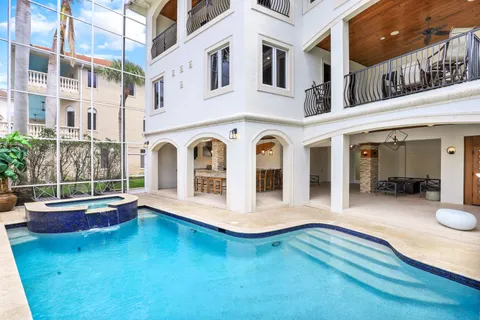 a view of a dining room with furniture and chandelier