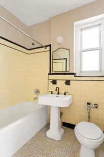 a bathroom with a sink a toilet and a bathtub
