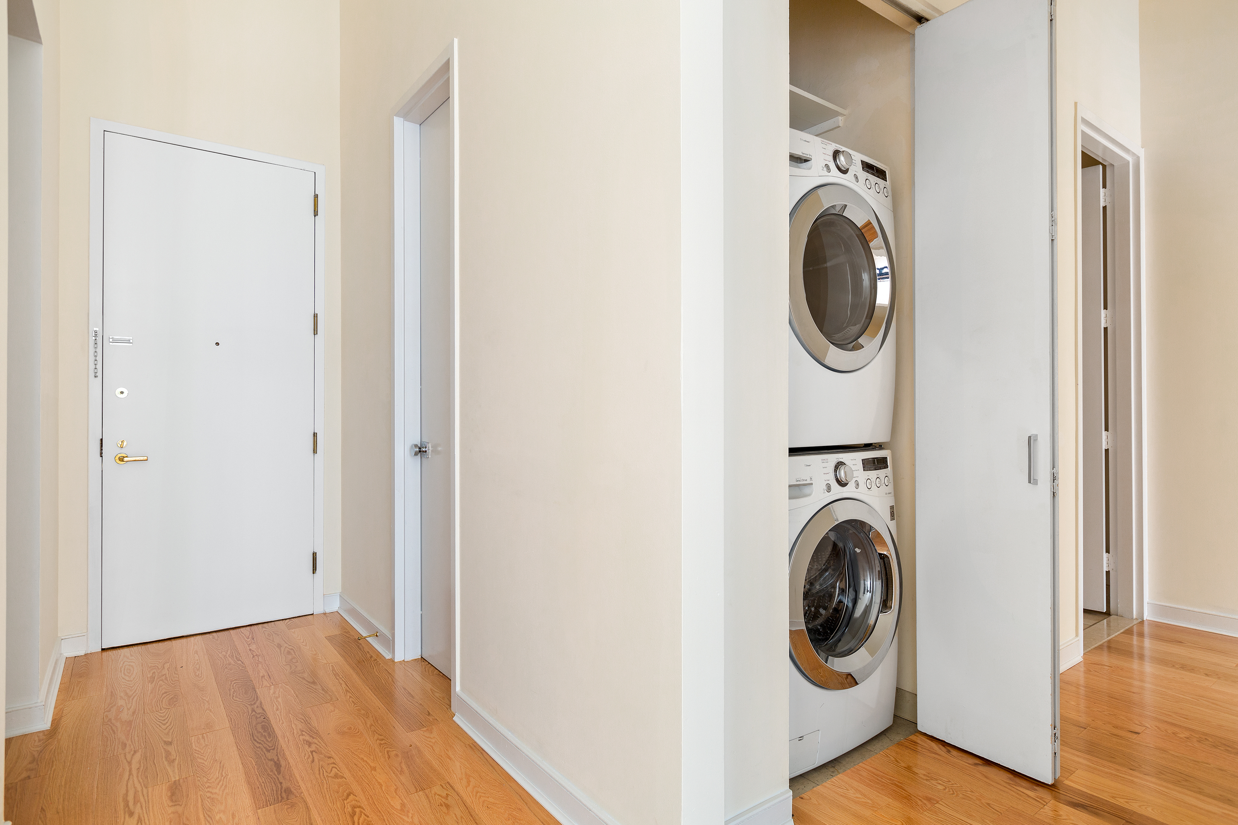 120 East 87th Street, Unit R10C Manhattan, NY 10128 - Photo 8 of 13 a view of a hallway with washer and dryer