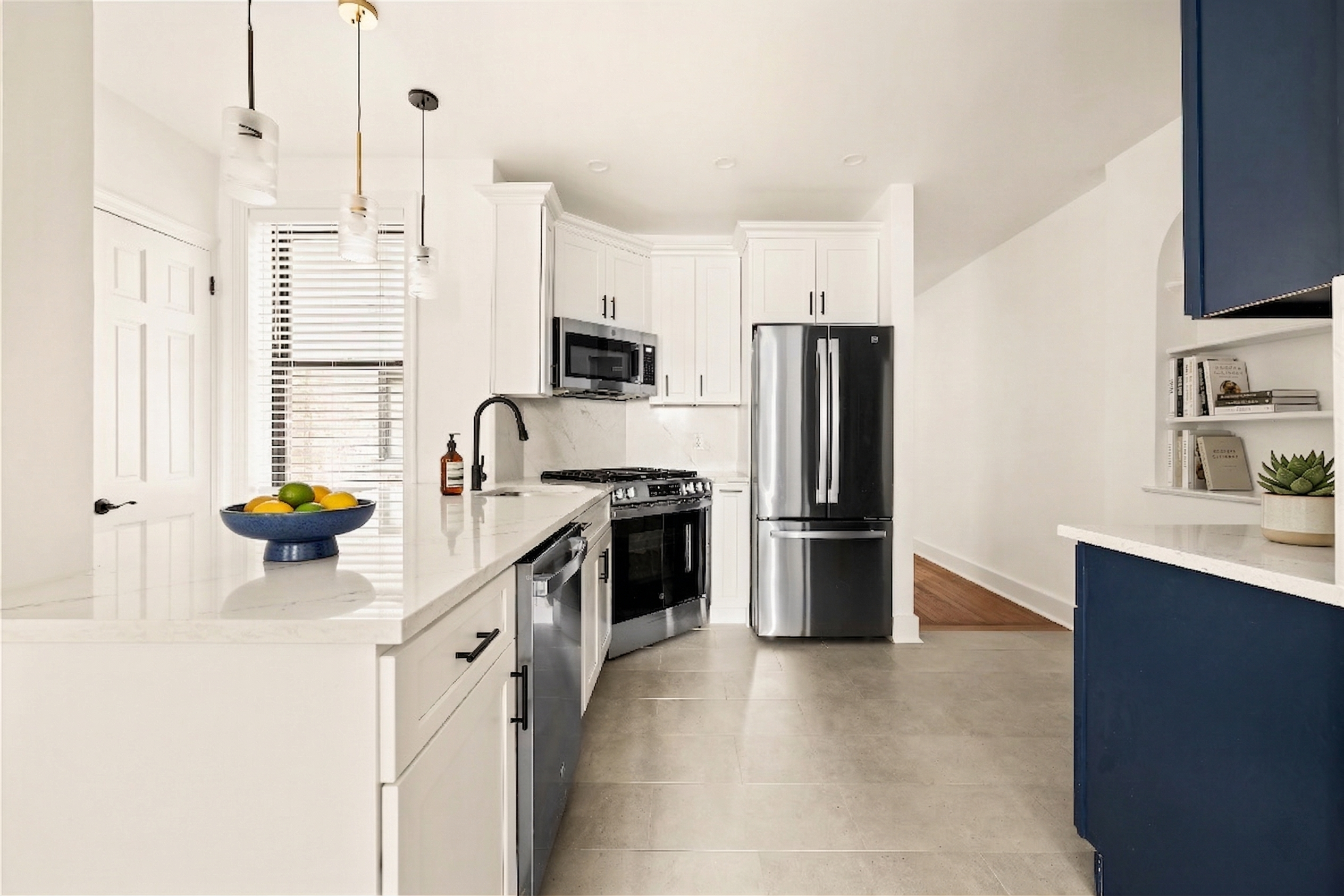 47-39 40th Street, Unit 1B Queens, NY 11104 - Photo 2 of 15 a kitchen with a sink a counter top space and stainless steel appliances