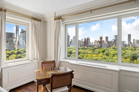 a view of a room with workspace windows and wooden walls