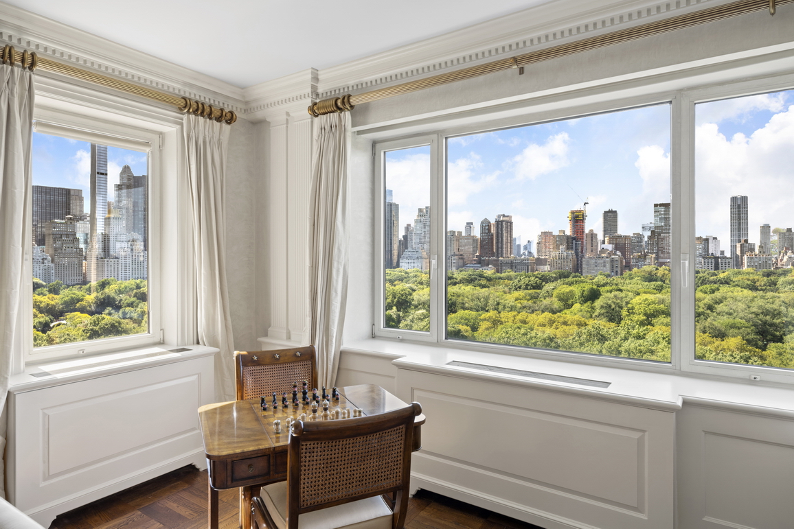 875 5th Avenue, Unit 18A Manhattan, NY 10065 - Photo 1 of 14 a view of a room with workspace windows and wooden walls
