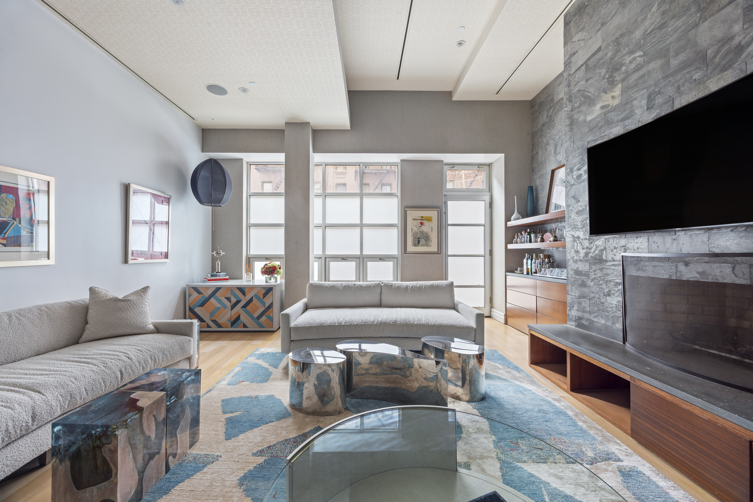 157 East 84th Street, Unit THA Manhattan, NY 10028 - Photo 5 of 33 a living room with fireplace furniture and a flat screen tv