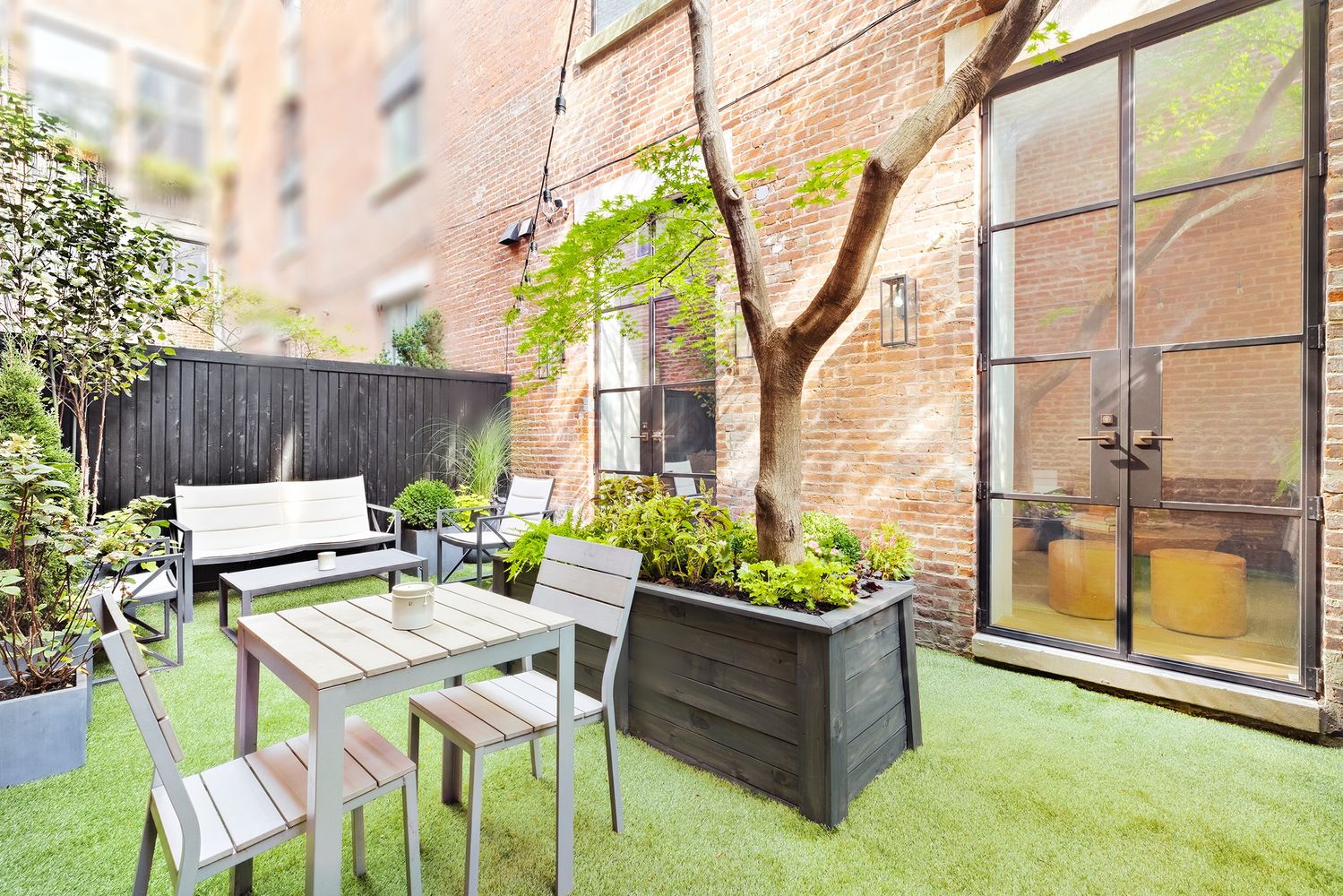 a view of a chairs and table in the back yard of the house