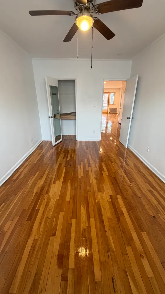 wooden floor in an empty room with a window