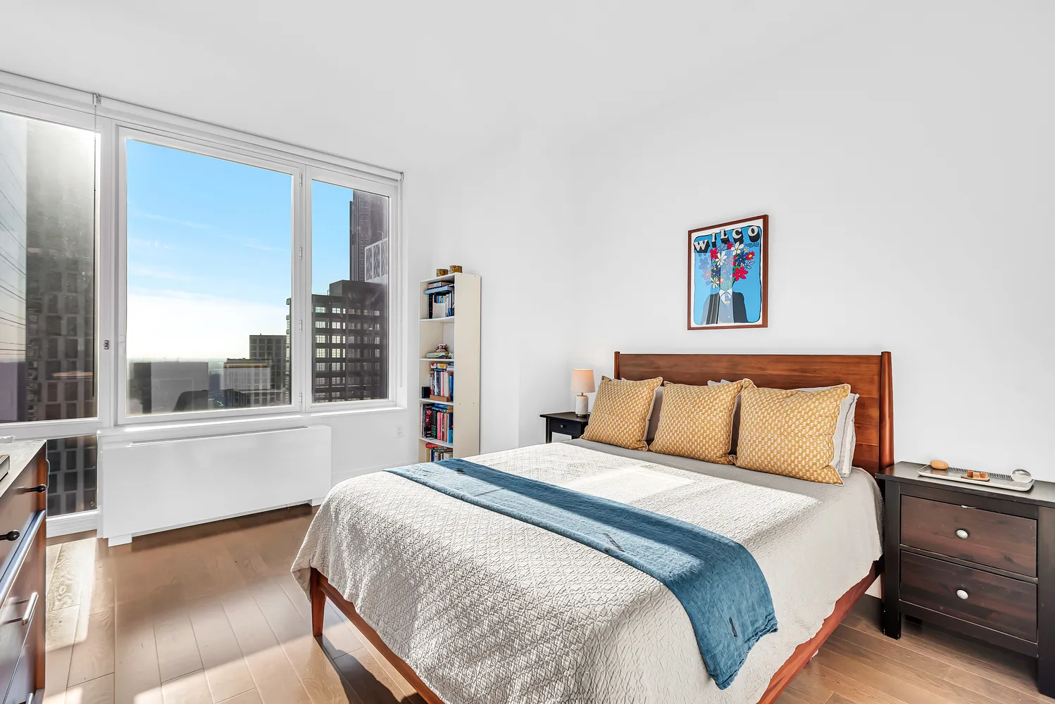 a bedroom with a large bed and a large window