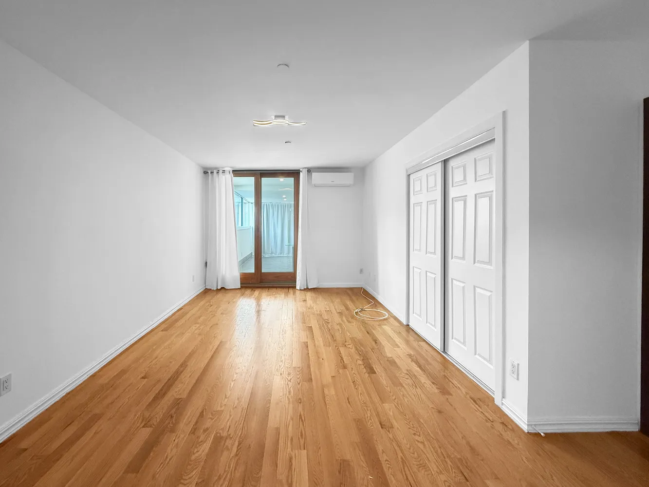 wooden floor in an empty room with a window