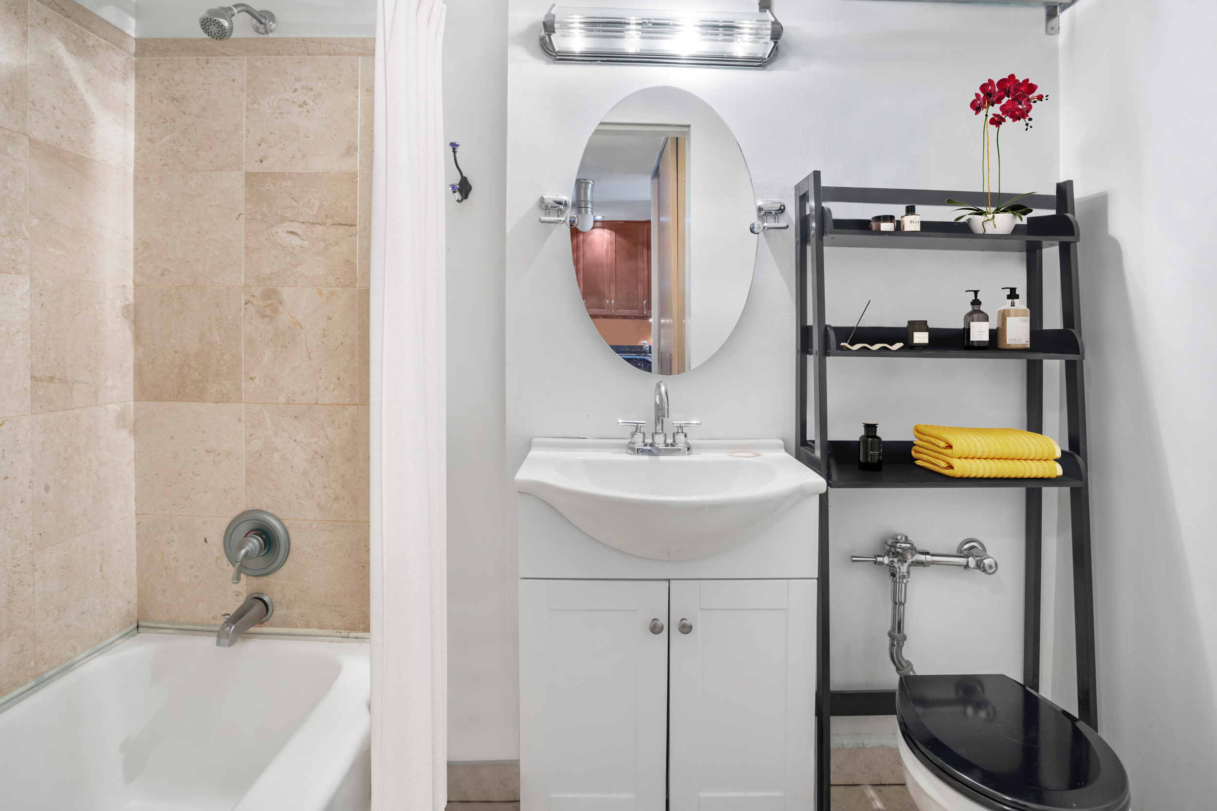 165 Christopher Street, Unit 6J Manhattan, NY 10014 - Photo 6 of 16 a bathroom with a sink a toilet and shower