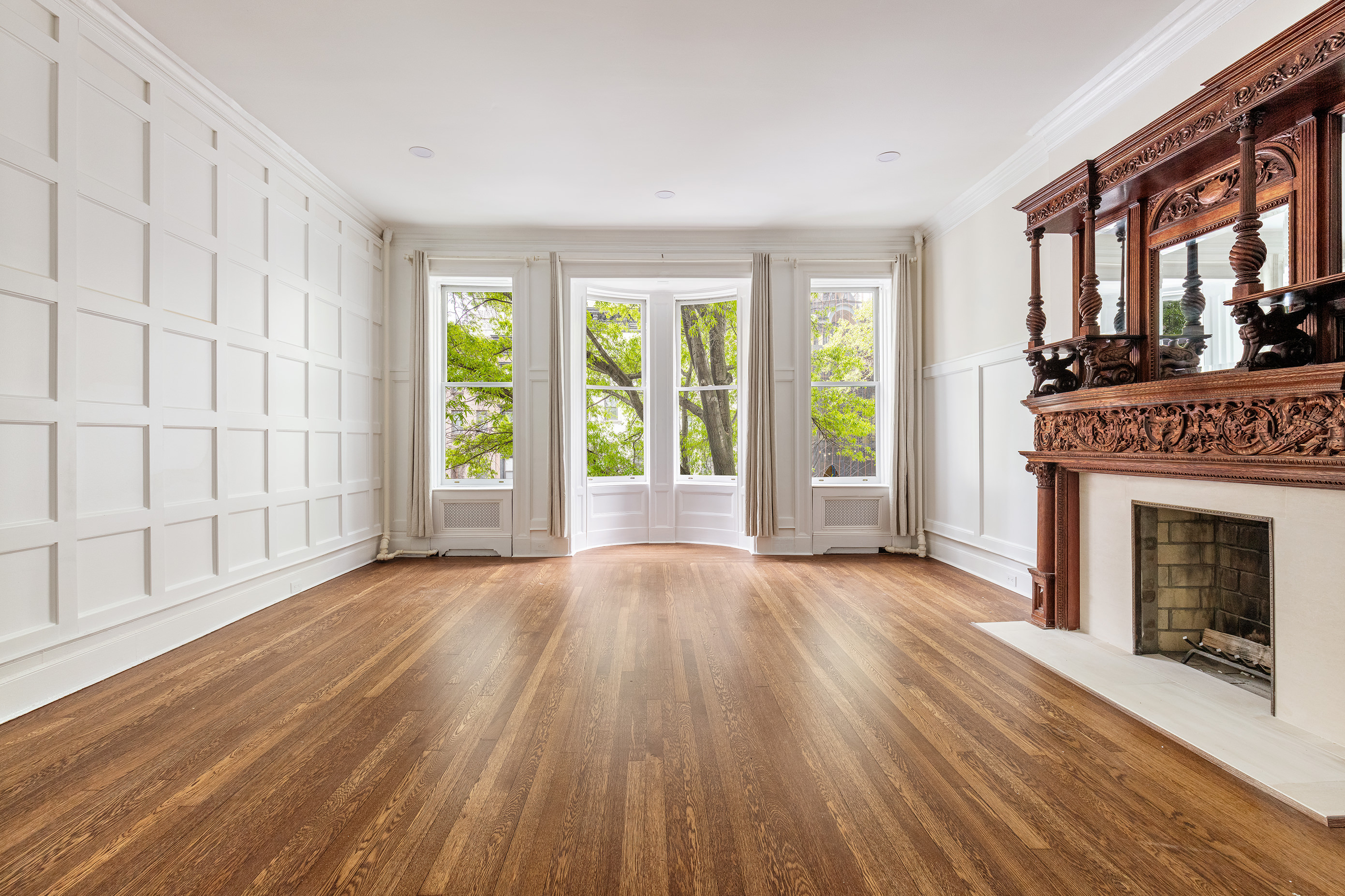 129 East 61st Street, Unit 3 Manhattan, NY 10065 - Photo 5 of 13 a view of an empty room with wooden floor and a window