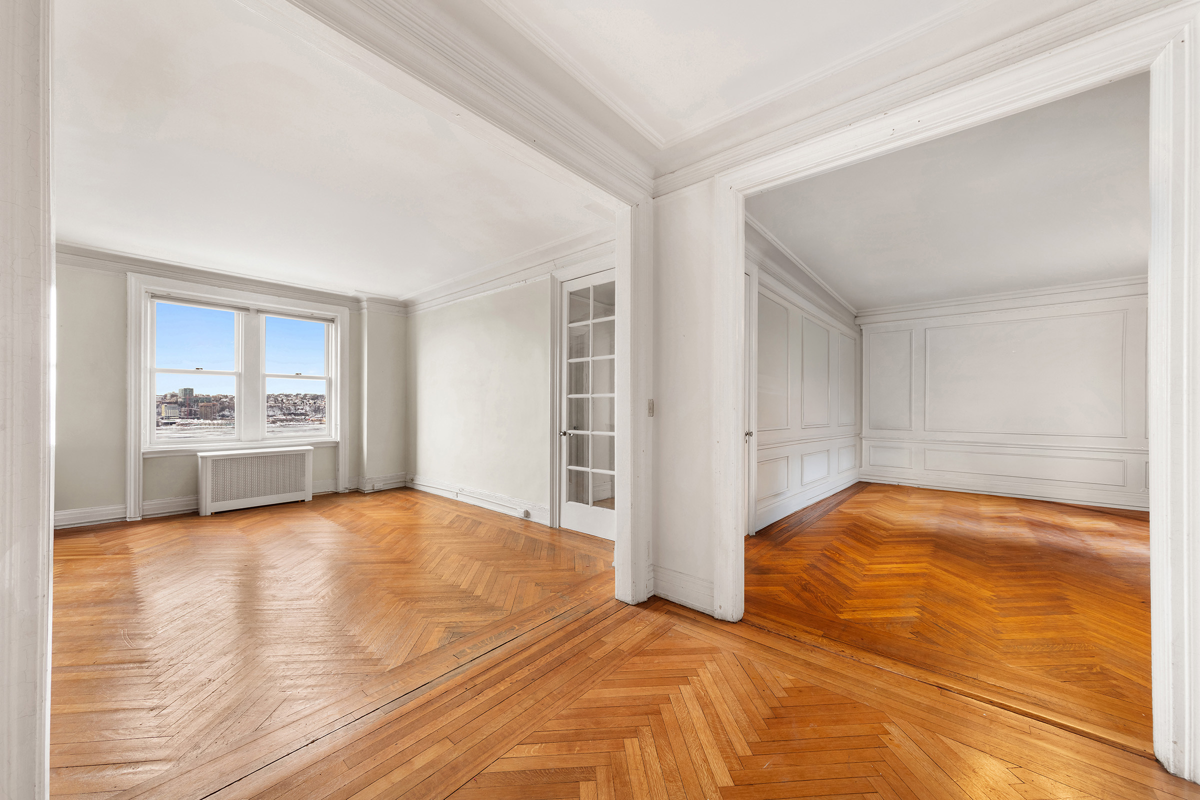 360 Riverside Drive, Unit 8A Manhattan, NY 10025 - Photo 11 of 20 a view of empty room with kitchen view and wooden floor