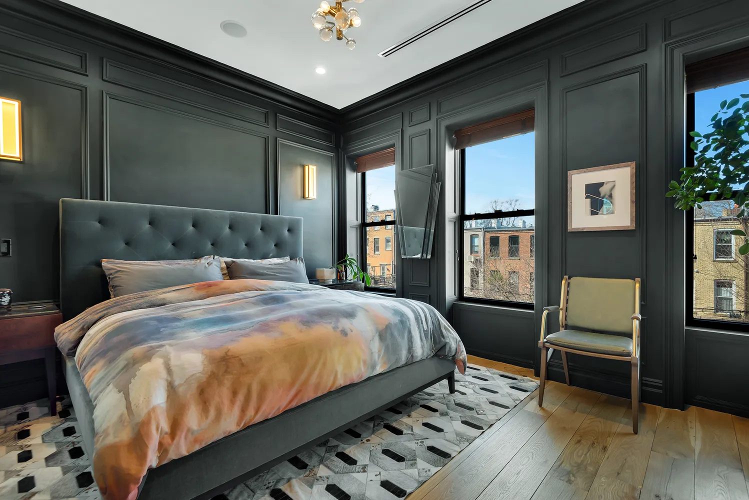 a bed sitting in a bedroom next to a window