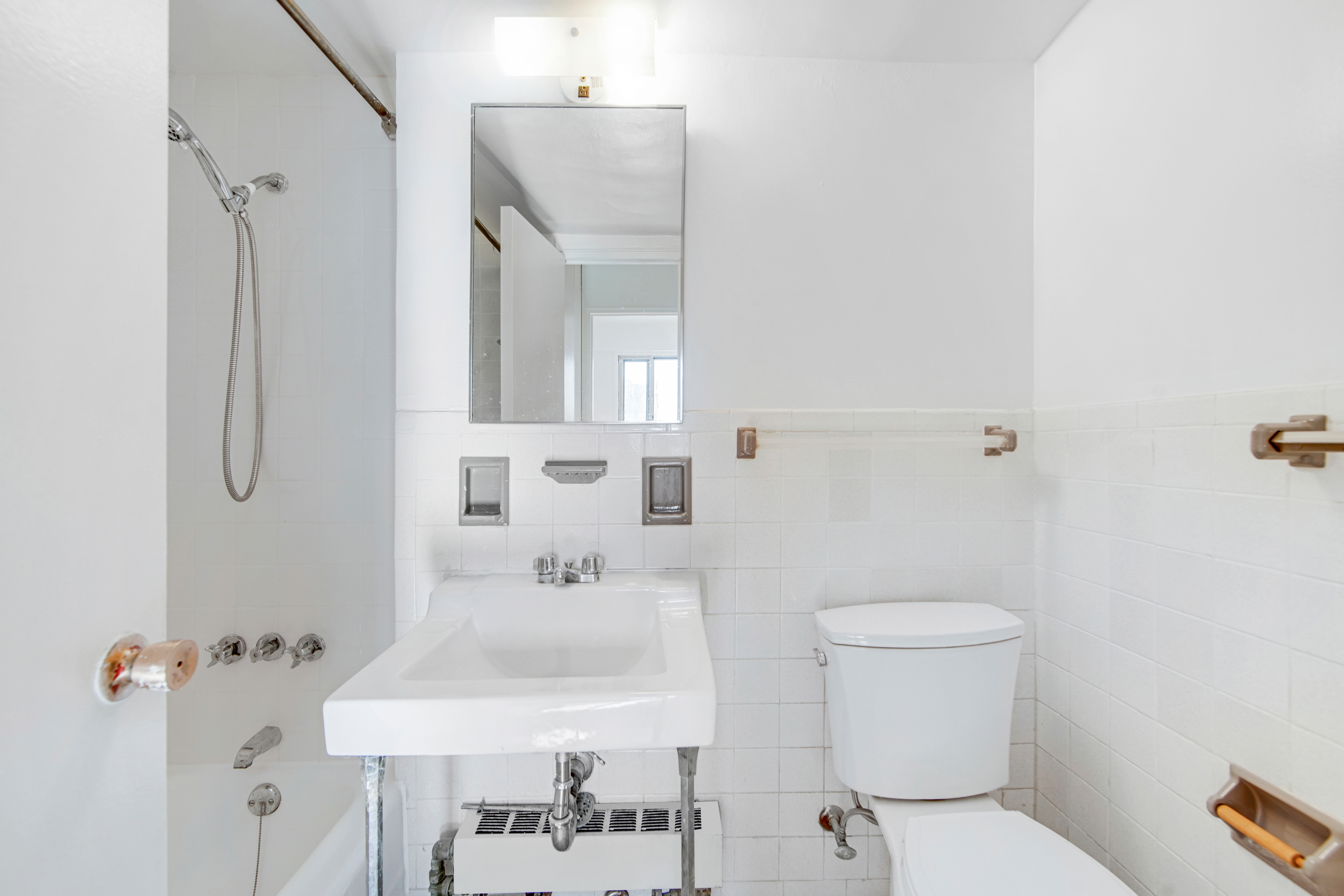 401 East 65th Street, Unit 10H Manhattan, NY 10065 - Photo 9 of 14 a bathroom with a sink toilet and shower