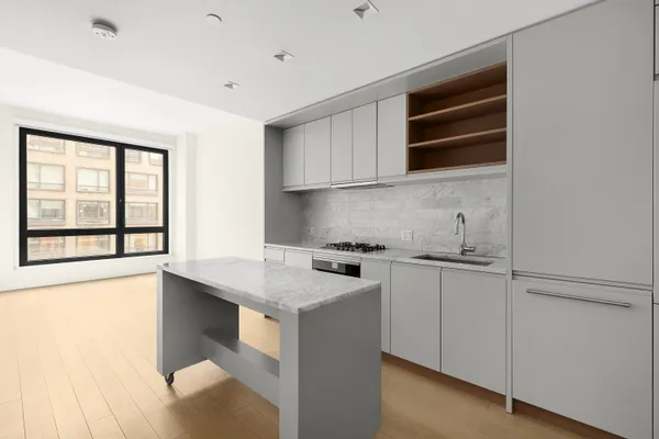 a kitchen with stainless steel appliances granite countertop a stove and a sink