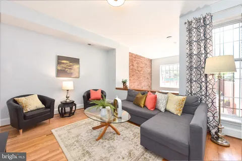 a living room with furniture and a lamp