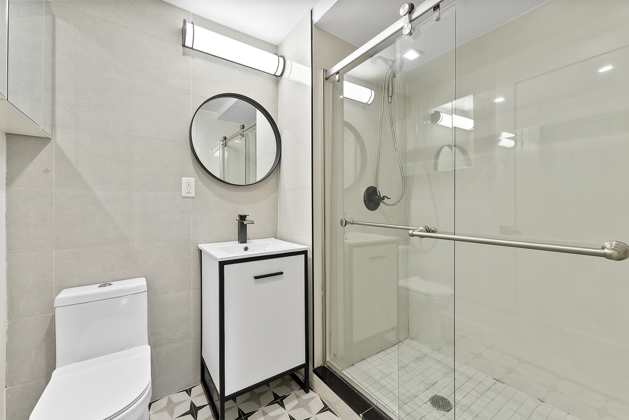 81 Eldert Street, Unit 1 Brooklyn, NY 11207 - Photo 8 of 9 a bathroom with a toilet a sink a mirror and vanity