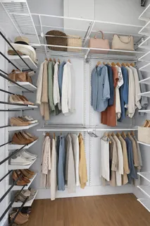 a view of walk in closet with clothes and shoes