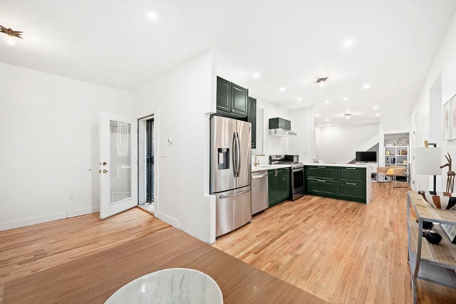400 West 154th Street, Unit 1 Manhattan, NY 10032 - Photo 1 of 10 a kitchen with stainless steel appliances kitchen island granite countertop a refrigerator and a sink