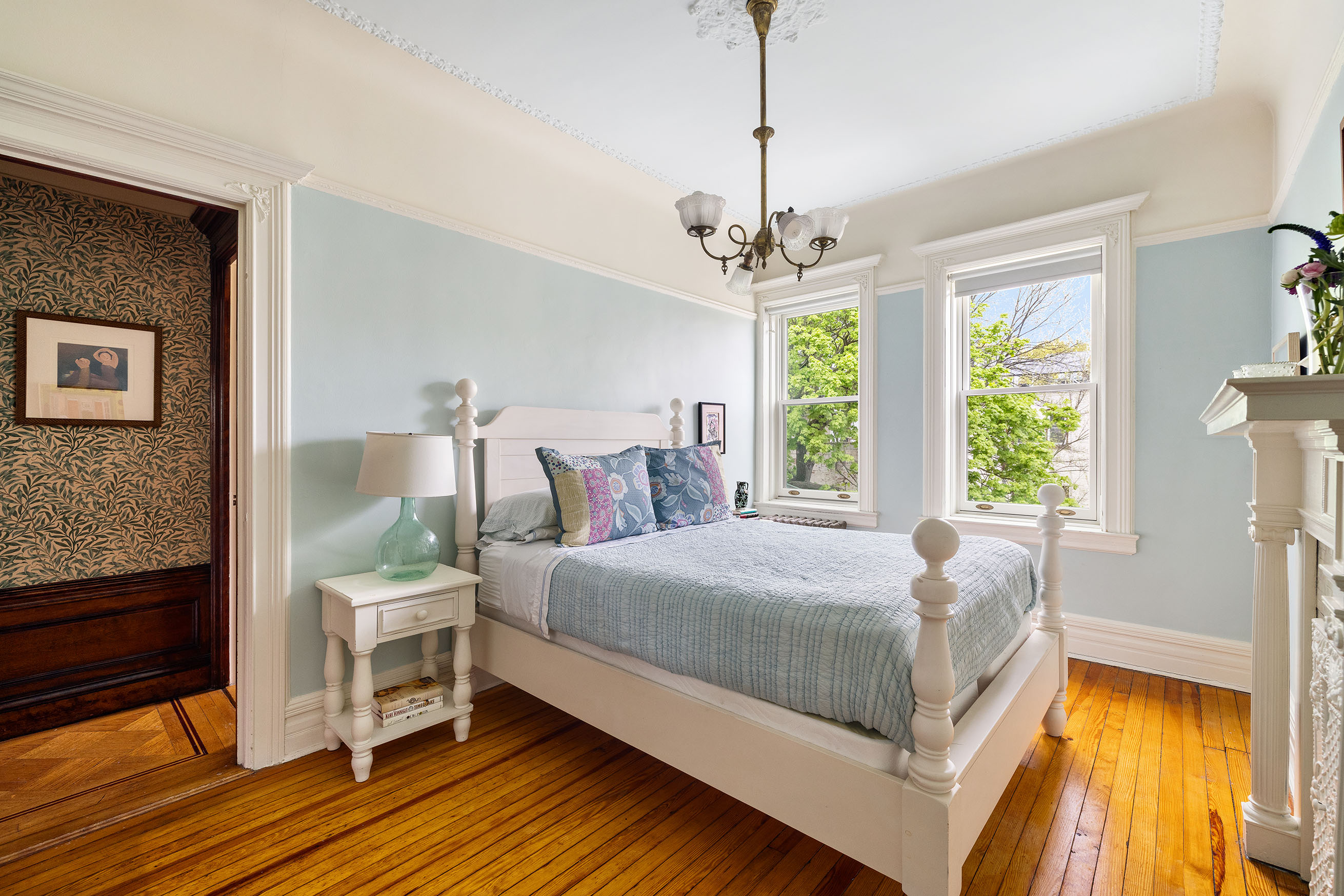577 4th Street Brooklyn, NY 11215 - Photo 16 of 22 a bedroom with a bed and a chandelier