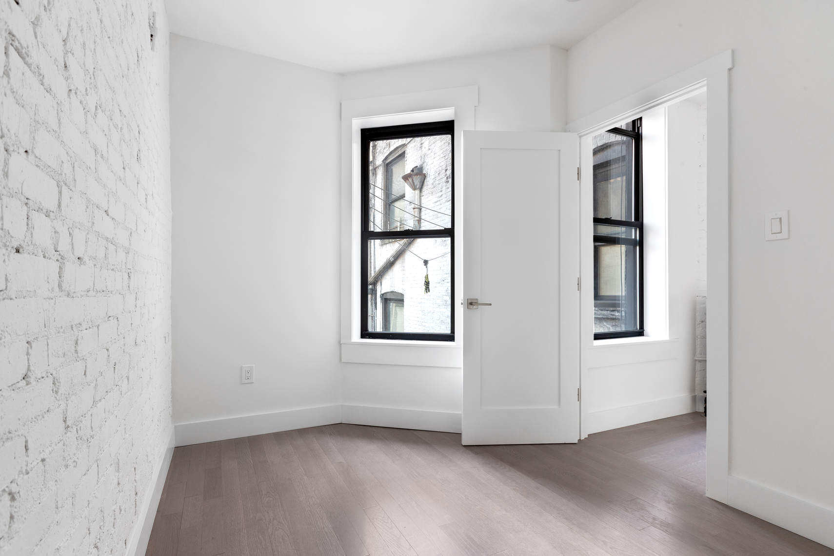 1392 Madison Avenue, Unit 24 Manhattan, NY 10128 - Photo 5 of 6 an empty room with windows and closet
